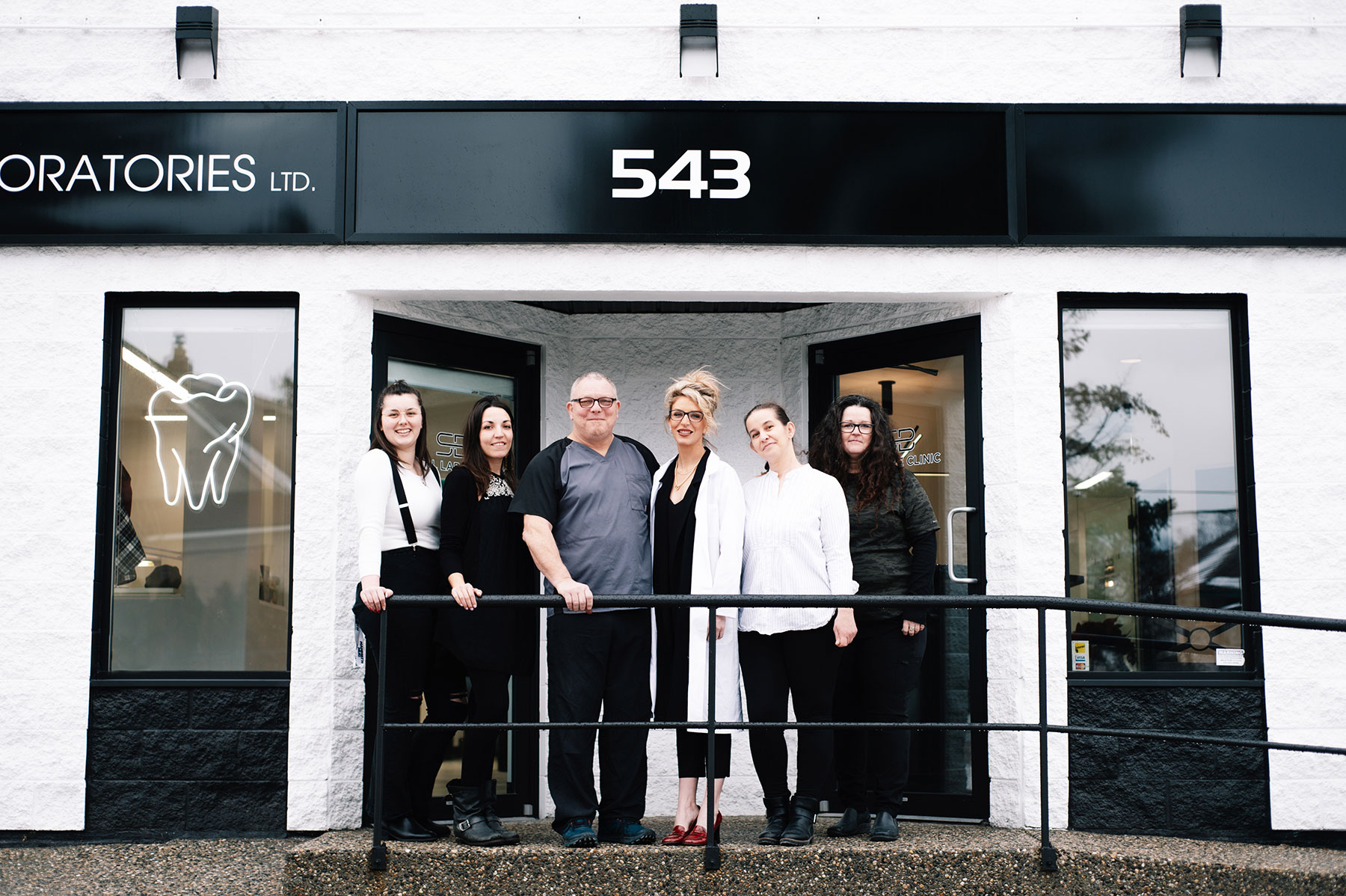 Meet the team at SB Denture clinic posed for a group photo in front of the clinic