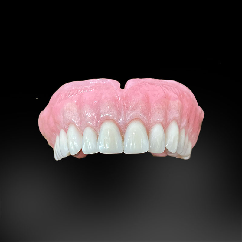 an image of an upper denture in front of a black background