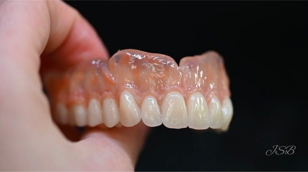 Person holding dentures